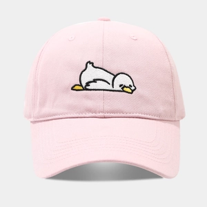Detailed close-up of pink cotton baseball cap with white cartoon animal embroidery