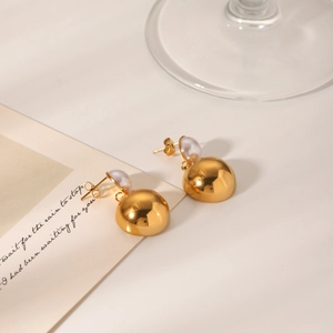 18k gold plated stainless steel semi-circle hoop earrings with pearl accents on white desk