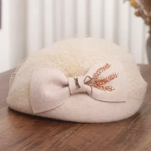 French vintage wool beret with mesh veil and bow accent in creamy white finish