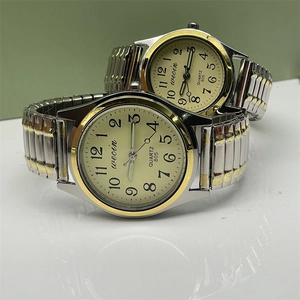 Close-up of quartz couple watches with elastic steel bands and large numeric dials