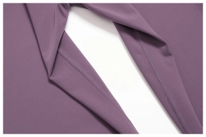 Macro detail of high-quality flatlock stitching and gusset on purple yoga pants