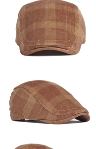 Close-up of brown plaid corduroy fabric texture on a vintage British style flat cap