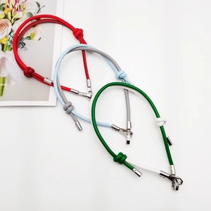 Detail of DIY leather phone lanyards in red, light blue and green with metal knots