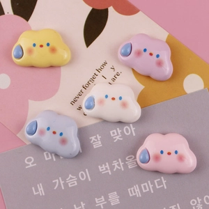 Close-up of colorful resin clouds with cute expressions for DIY phone case making