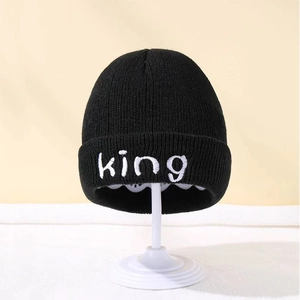 Classic black knit beanie for kids with white king embroidery on the folded cuff