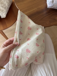 Detailed shot of floral cotton cosmetic bag with zipper closure and soft texture