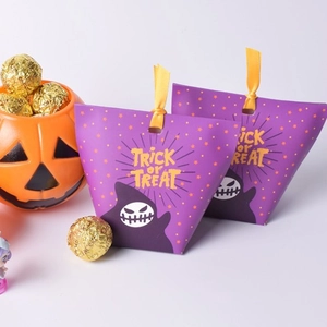 Halloween gift paper bags in purple with ghost patterns and yellow ribbon ties