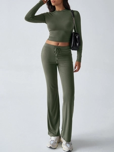 Detail of olive green Y2K two-piece set featuring long sleeve crop top and flared pants