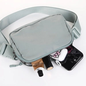 Versatile light grey running waist bag showing internal storage for phone and cosmetics
