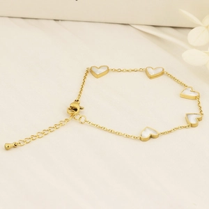 Golden heart link bracelet with white shell charms and adjustable clasp for women