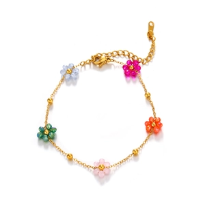 Golden flower bracelet with colorful floral charms and polished beads on white background