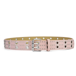 Detail of pink punk leather belt featuring double row silver eyelets and metal pin buckle