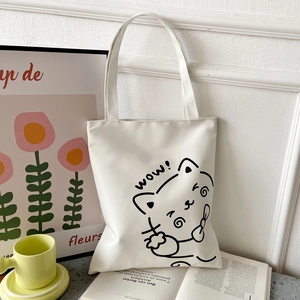White canvas tote bag featuring a cute cat illustration and 'wow!' text in a lifestyle set