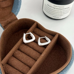 Minimalist silver geometric triangle hoop earrings displayed in a heart velvet jewelry box