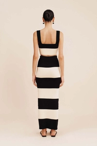 Rear view of striped knit set featuring a backless crop top and bodycon maxi skirt