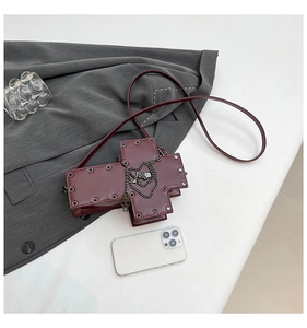 Gothic cross shaped crossbody bag in wine red with silver studs and skull chain detail