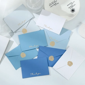 Detail of blue and white stationery set with gold foil Thank You text and wax seal