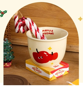 Detail of Christmas ceramic mug with reindeer print, candy cane and festive background
