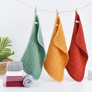 Soft multi-color 100% cotton muslin baby burp cloths hanging on a rope for display
