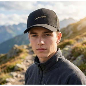 Outdoor close-up of a black baseball cap with NYC embroidery worn by a man in nature