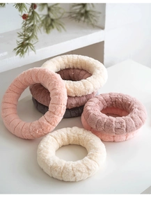 Macro detail of plush wool felt Christmas wreaths with soft striped texture in Morandi tones