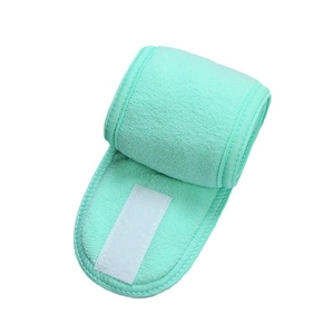Detail showing mint green face wash headband with adjustable white velcro closure