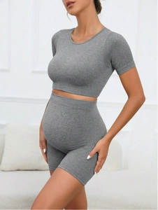 Detail of high-waist seamless maternity yoga set showing ribbed texture and belly support