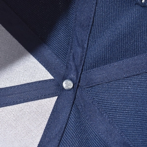 Macro detail of the interior crown stitching and metal rivet of the navy baseball cap