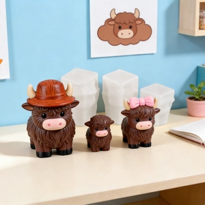 Three sizes of Highland cow figurines in chocolate brown with cute hats and bows decor