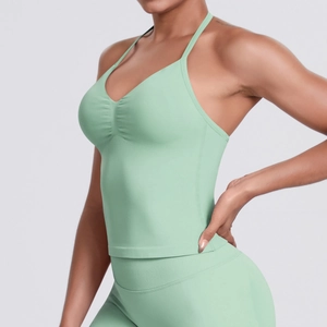 Detail of mint green seamless ribbed yoga tank top fabric with elegant V-neckline pleats