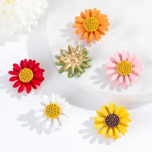 Detail view of colorful daisy brooches and back pin closure in matte finish