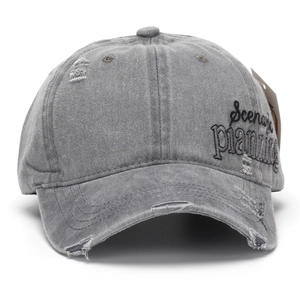 Detail of grey washed denim baseball cap with side Scena planning embroidery and distressed rips