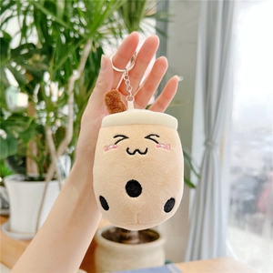 Close-up of a cute plush bubble tea keychain with smiling embroidery held in hand