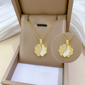 Detail of gold shell pendant with crystals in a beige jewelry gift box for women
