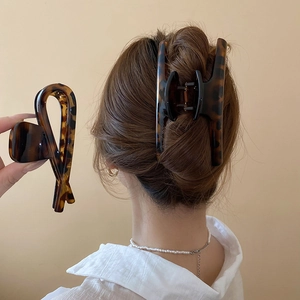 Macro detail of large tortoise shell hair claw clip for elegant women's updos