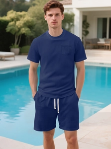 Detail of dark blue waffle knit fabric on men's t-shirt with functional chest pocket