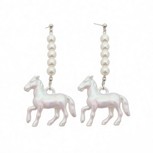 Elegant pearl earrings with iridescent unicorn charm and silver studs on white background