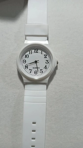 Macro shot of white silent quartz exam watch for students featuring clear Arabic numerals
