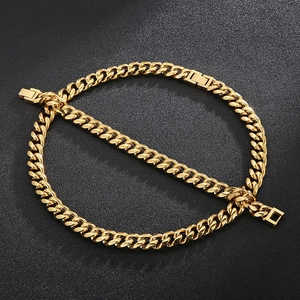 Detail shot of golden Cuban link chain necklaces with square lobster clasps and flat links