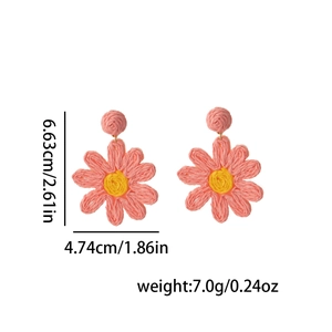 Macro shot of pink raffia flower earrings with dimensions 6.63cm height and 4.74cm width