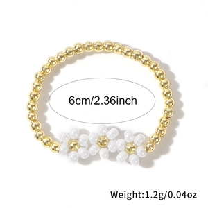 Handmade woven daisy seed bead ring with three small white flowers and gold copper beads