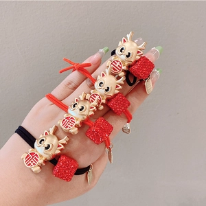 Detail of golden dragon charms and red textured beads on high-elastic hair ties