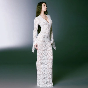 Detailed view of white lace maxi dress featuring deep V-neck and sheer floral mesh pattern