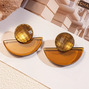Golden textured studs with amber resin semi-circle fan drops on a minimalist backdrop