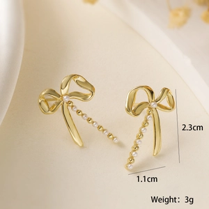 Detail view of gold-plated bow pearl earrings with dimensions 2.3cm by 1.1cm and 3g weight