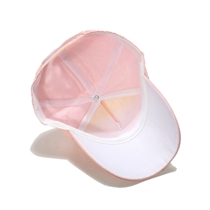 Detailed interior of a pink baseball cap with adjustable buckle and white brim underside