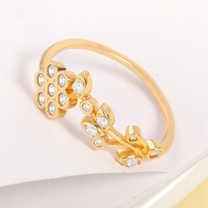 Macro shot of gold floral ring with leaf design and sparkling zircon stone inlay