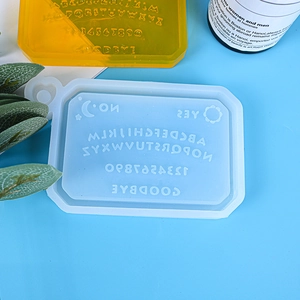 Macro view of Ouija board silicone resin mold and finished yellow epoxy casting