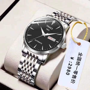 Close-up of men's steel watch with black dial showing day date display and logo detail