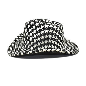 Detailed view of the houndstooth pattern fabric and texture on the wide-brim wool hat